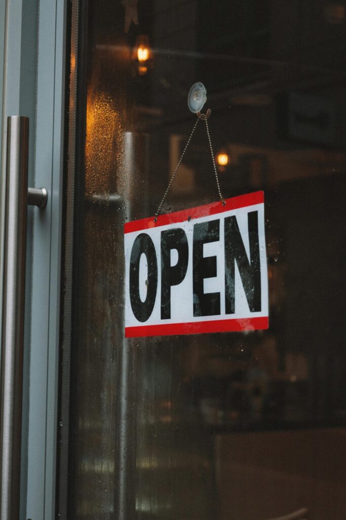 Open sign hanging in the window of a local business